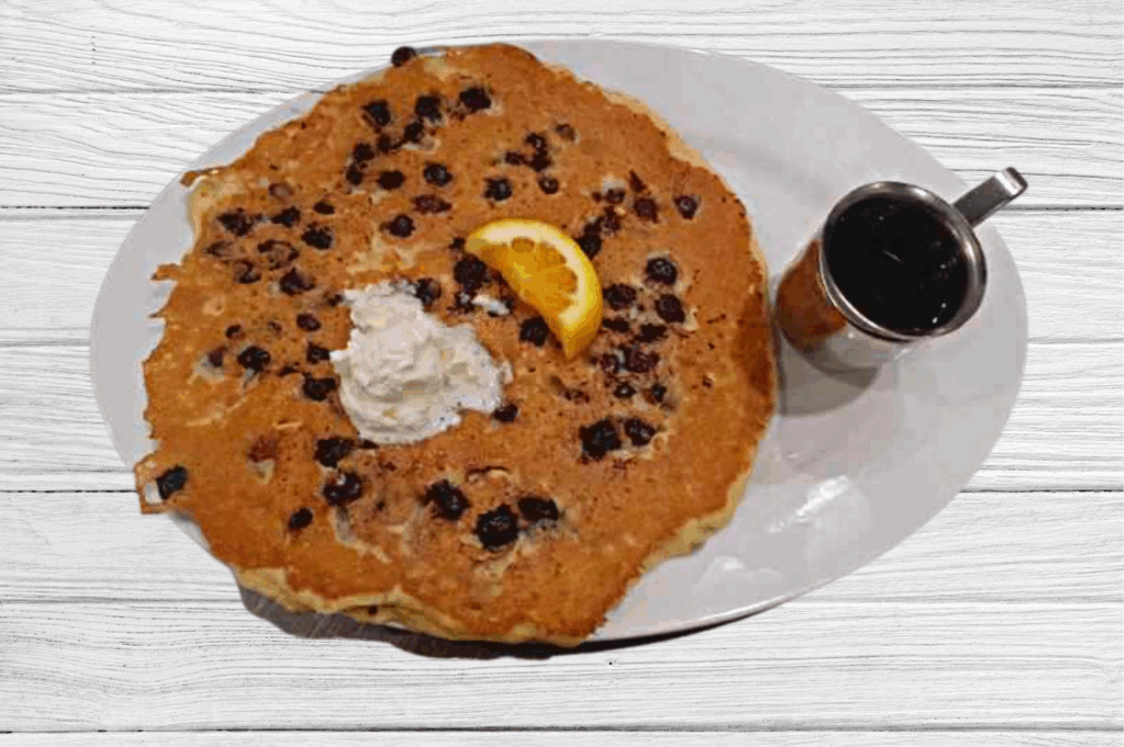 How Hash House A Go Go makes massive blueberry pancakes with whipped cream and syrup—a must-try breakfast classic.