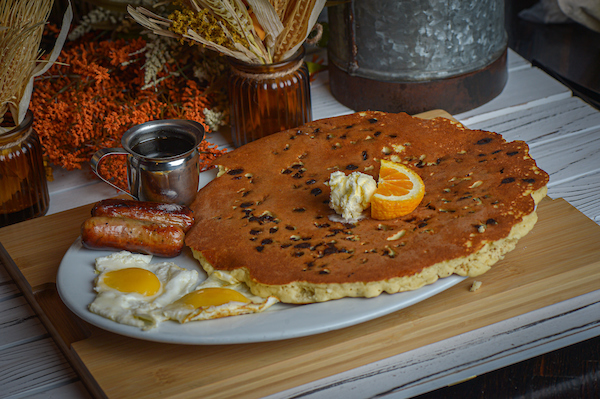 Giant chocolate chip pancake breakfast with eggs and sausage at Hash House A Go Go Mohegan Sun Montville