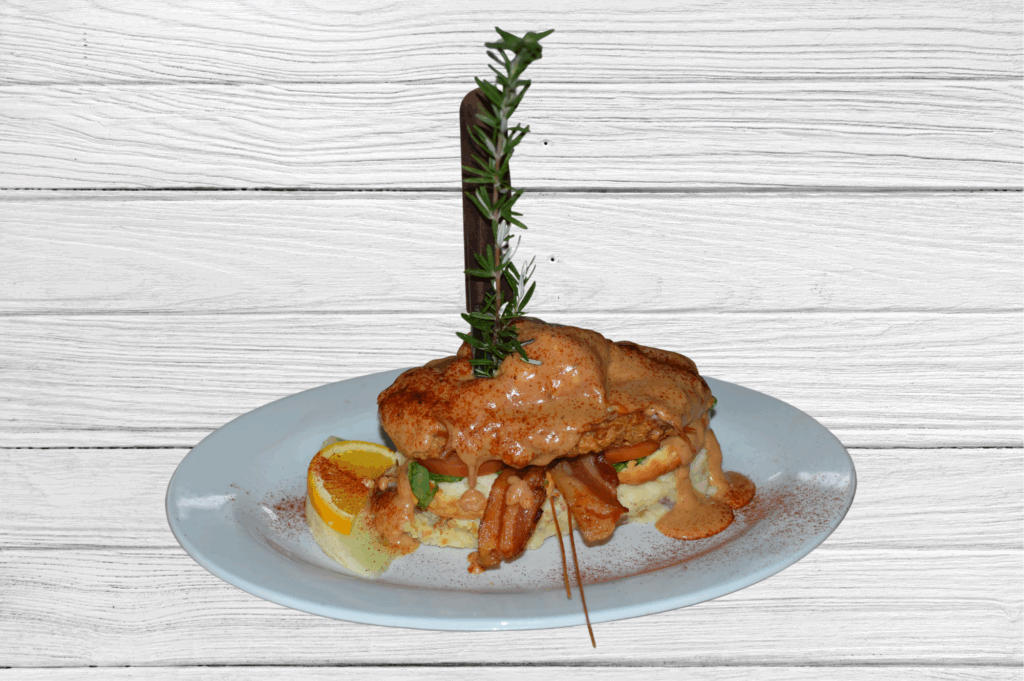 Sage Fried Chicken Benedict served at Hash House A Go Go, topped with cream and garnished, a favorite comfort dish in Montville.