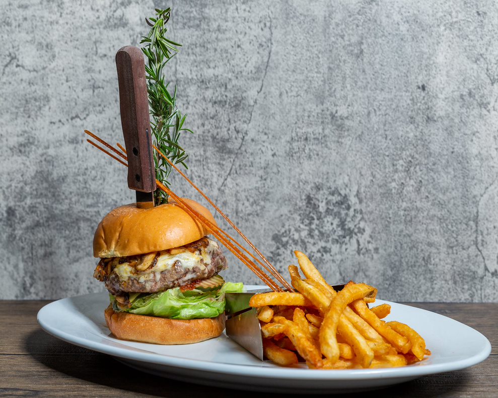Hash House A Go Go Twisted Burger with cheese, lettuce, and crispy fries at Mohegan Sun.