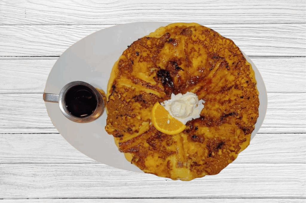 Comfort food at its finest with our Brown Sugar Banana Twisted Flapjack at Hash House A Go Go Mohegan Sun in Uncasville CT—oversized caramelized banana pancake with butter and syrup
