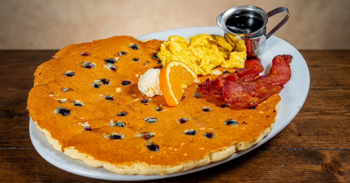 Oversized blueberry breakfast with scrambled eggs, crispy bacon, butter and syrup at Hash House A Go Go Mohegan Sun